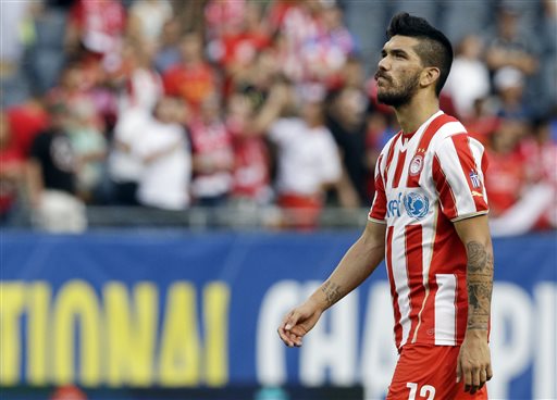 Olympiacos midfielder Dimitris Kolovos he walks off the field after his team lost to the Liverpool FC 1-0 in an International Champions Cup soccer match in Chicago, Sunday, July 27, 2014. (AP Photo/Nam Y. Huh)